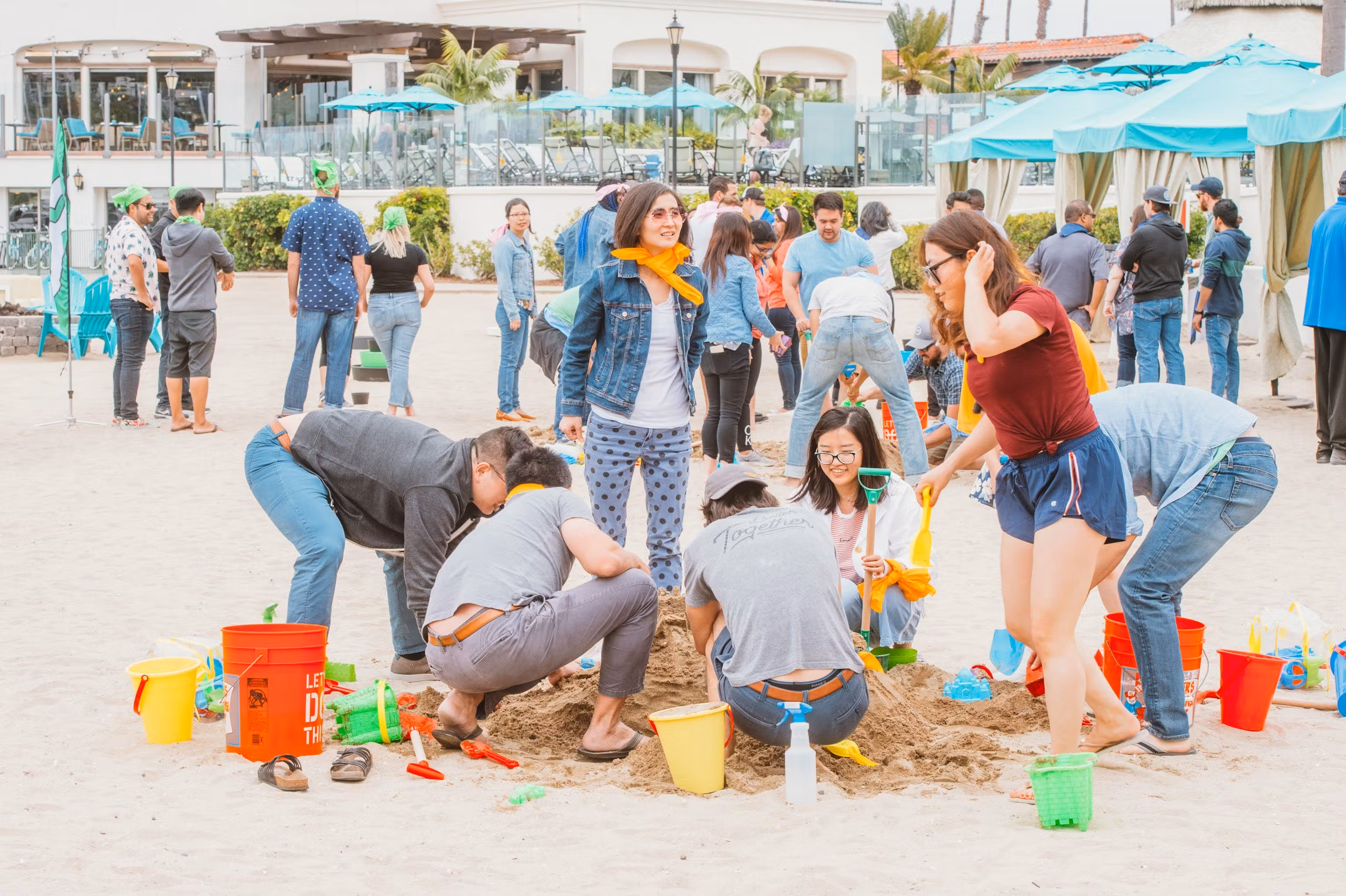 Teams building a sandcastle during a beach program